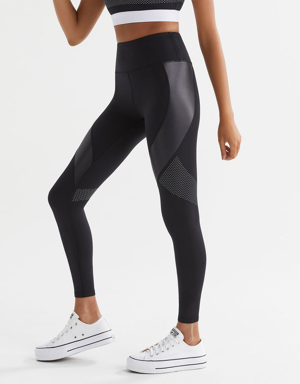 Black leggings with mesh panels worn by a person on a white background