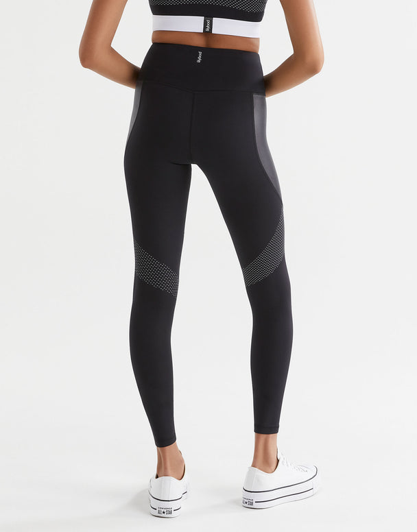 Black leggings with white accents worn by a person on a white background