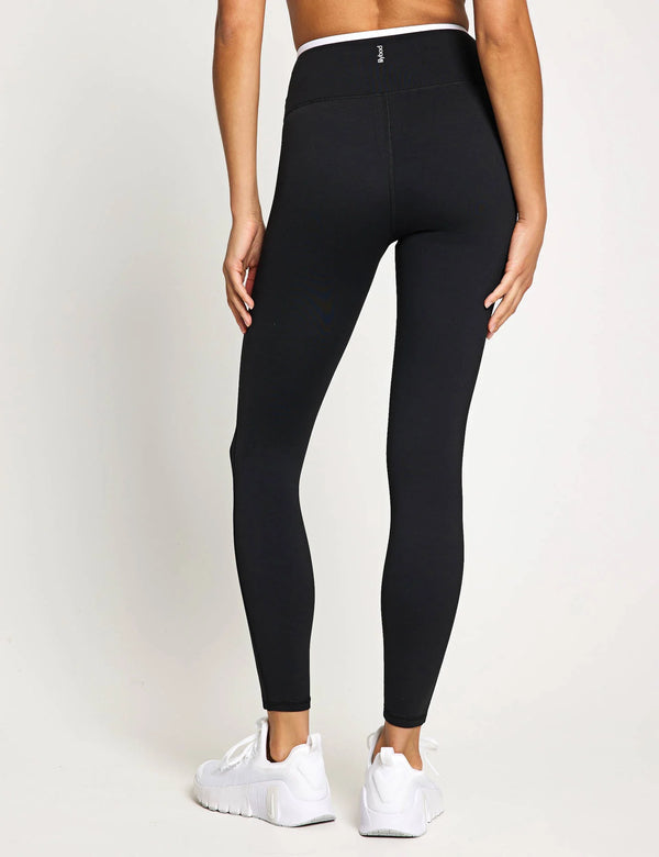 Person wearing black leggings on a white background