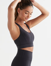A model wearing a black Lilybod Frankie Cloud-Core Sports Bra with wide straps and removable padded cups.