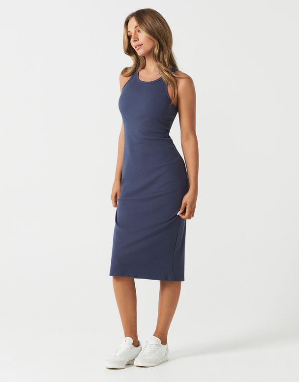 Woman wearing a navy blue sleeveless dress on a white background