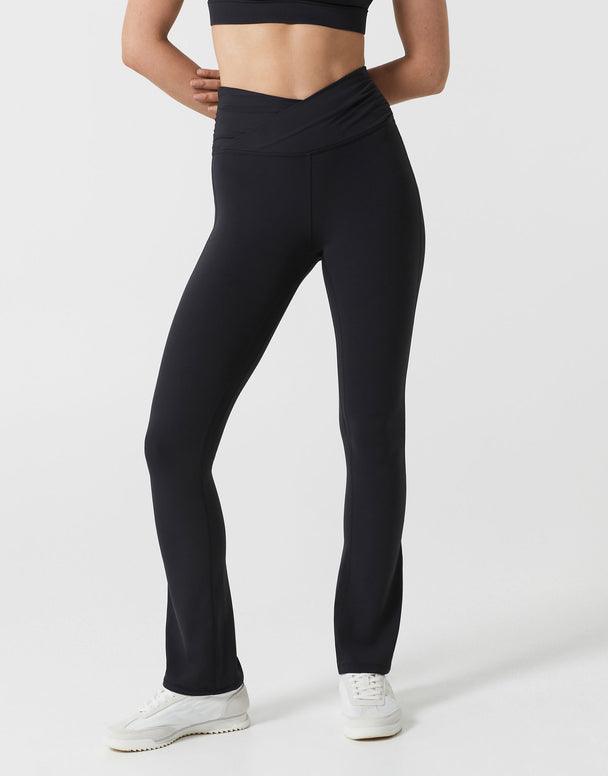 Person wearing black leggings on a white background