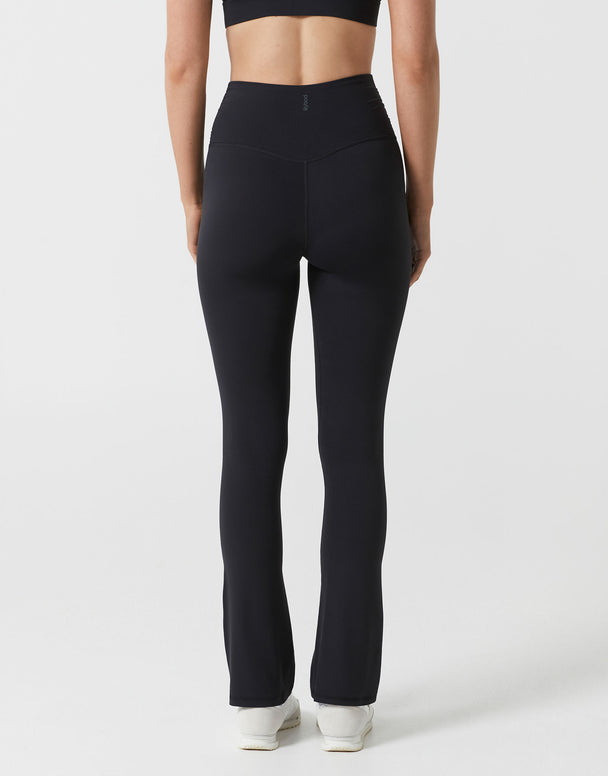 Person wearing black leggings on a white background