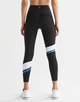 Black leggings with white and blue accents worn by a person on a white background