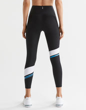 Black leggings with white and blue accents worn by a person on a white background