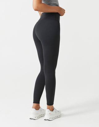 Person wearing black leggings on a white background