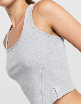 Gray tank top worn by a person on a light gray background
