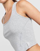Gray tank top worn by a person on a light gray background