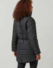 Person wearing a black puffer coat on a light gray background