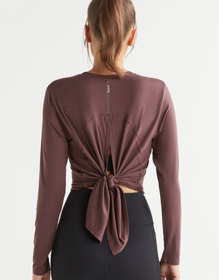 Brown long-sleeve top with knot detail on a white background