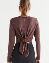 Brown long-sleeve top with knot detail on a white background
