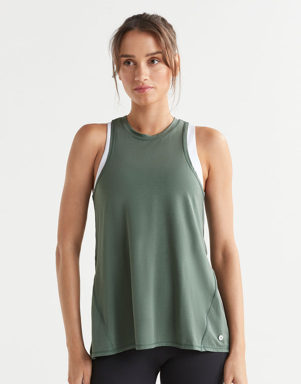 Woman wearing a green tank top on a white background
