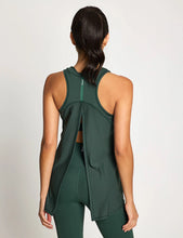 Woman wearing a green athletic outfit on a light gray background