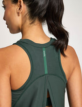 Green athletic tank top worn by a person, focusing on the back design.