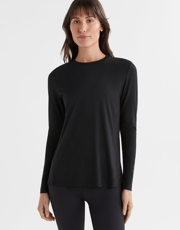 Woman wearing a black long-sleeve top on a white background
