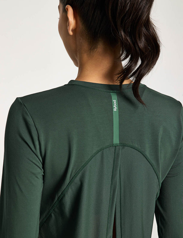 Green athletic shirt worn by a person on a white background