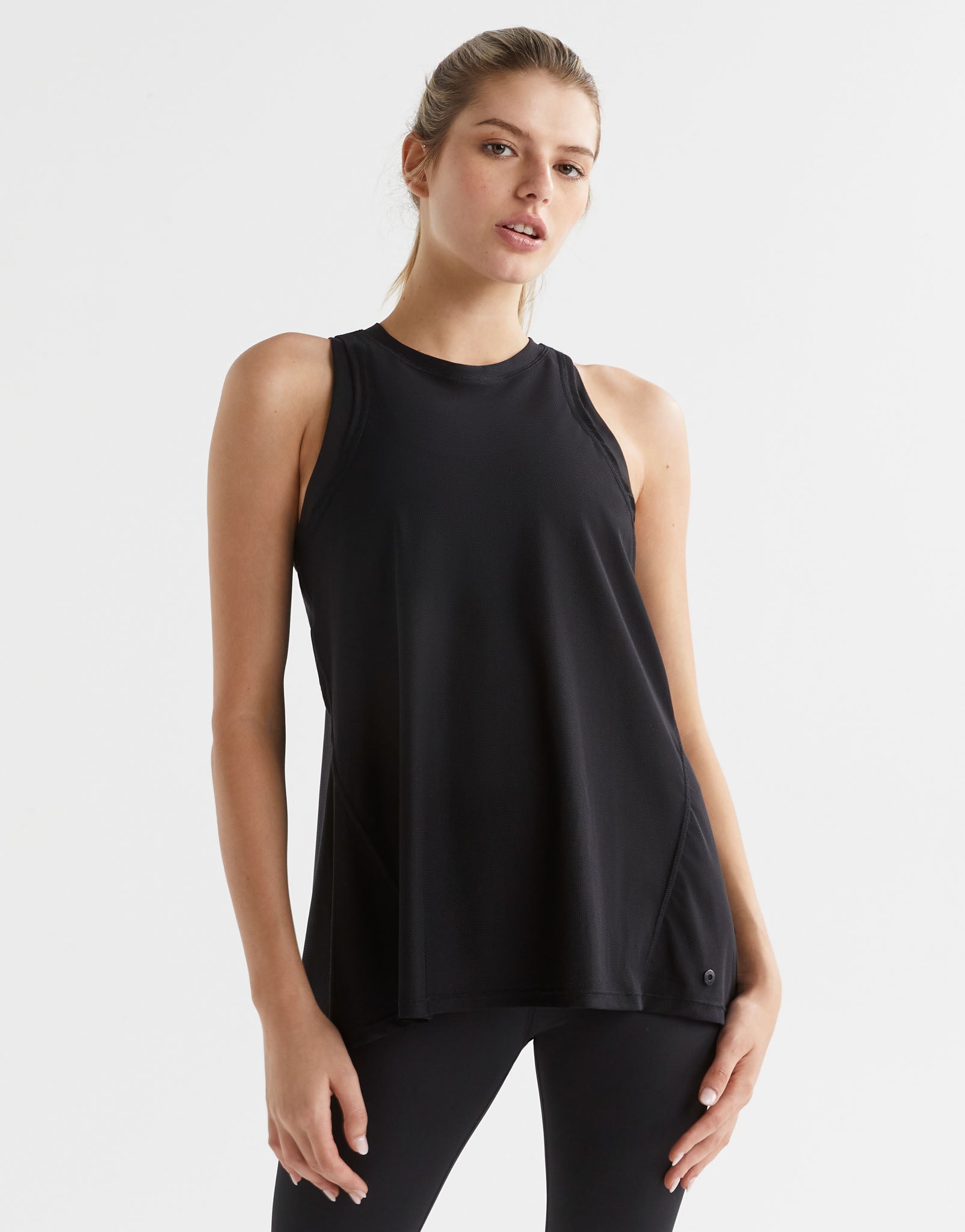 Woman wearing a black sleeveless top on a white background