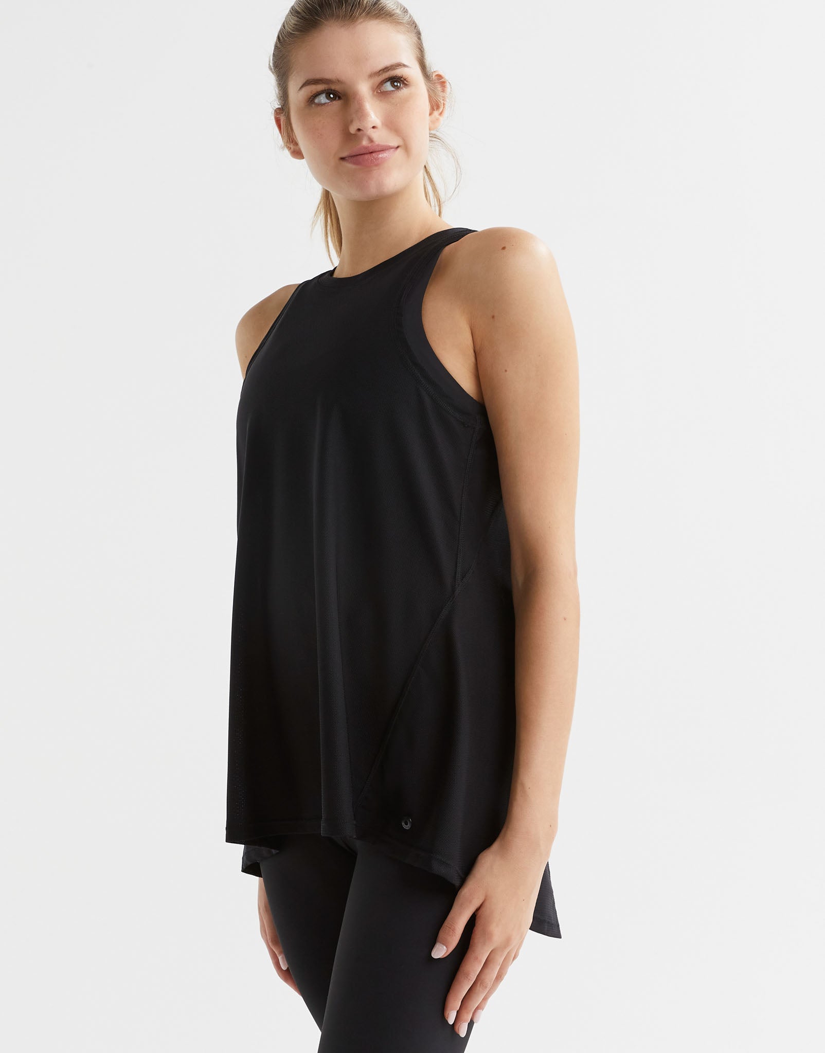 Woman wearing a black sleeveless top on a white background