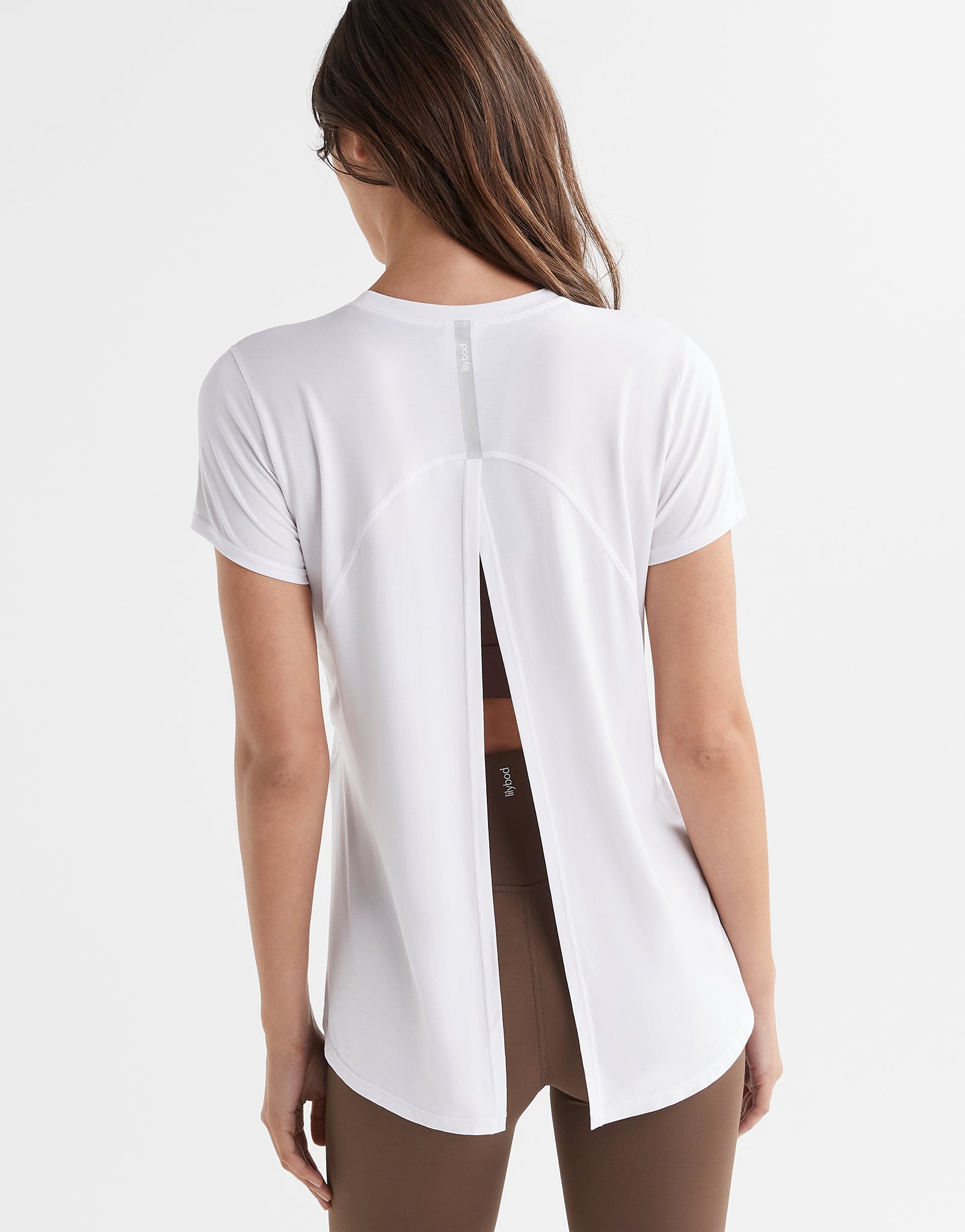 Women wearing a white t shirt with athletic leggings