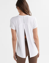 Women wearing a white t shirt with athletic leggings
