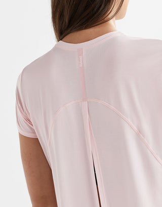 Close up of a pink top with a logo.