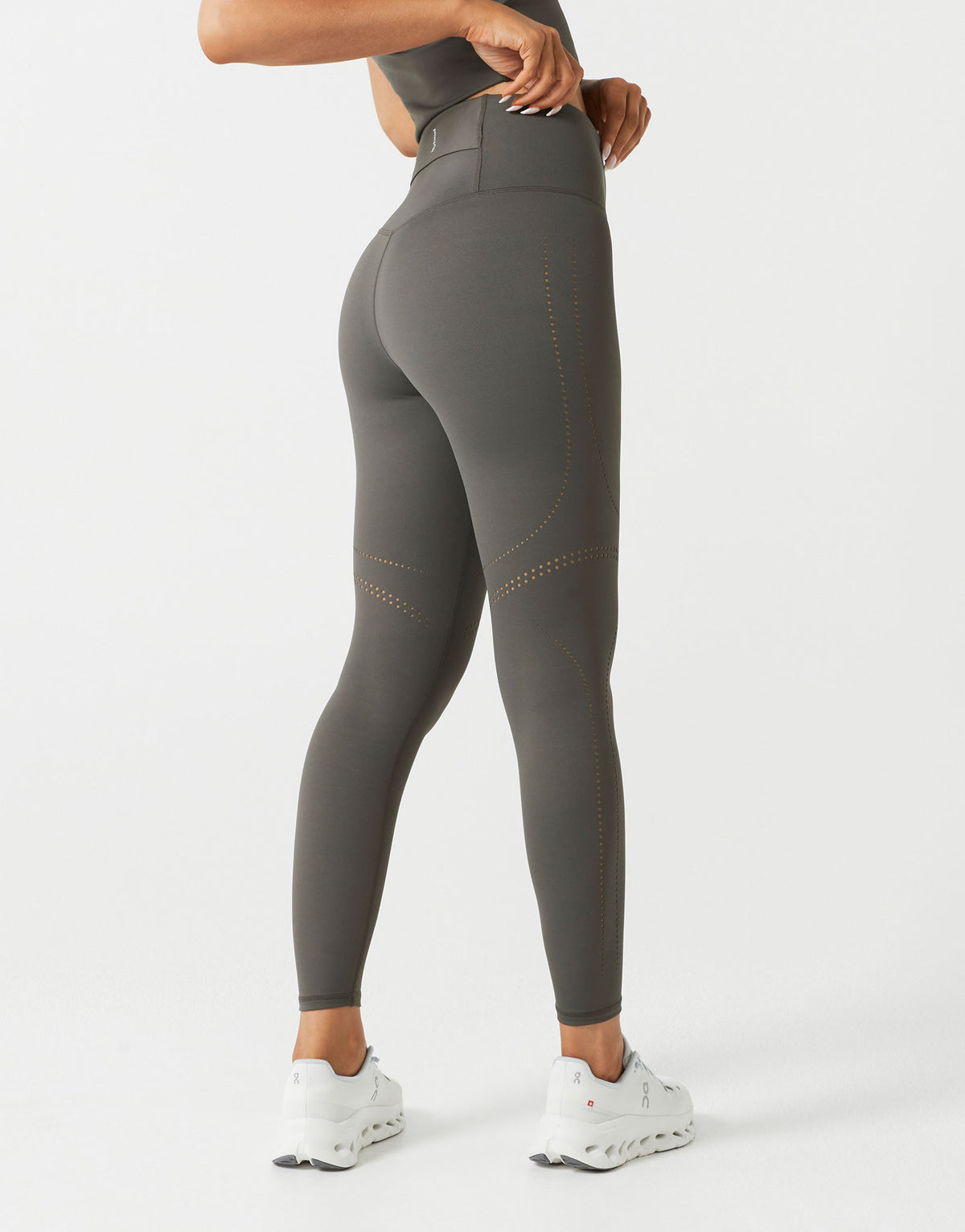 Person wearing gray leggings with a white background