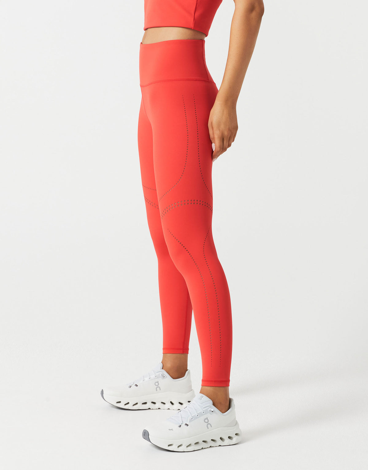 A woman wearing red leggings on a white background.