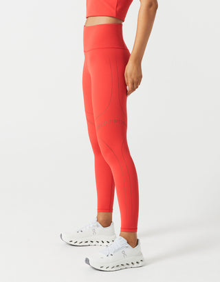 A woman wearing red leggings on a white background.