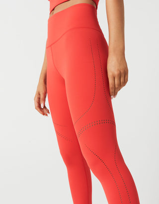 A woman wearing red leggings and a  red top on a white background.