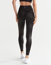 Person wearing black leggings on a white background