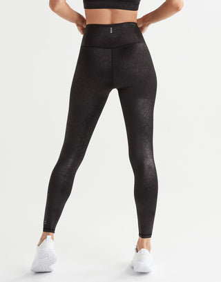 Person wearing black leggings on a white background
