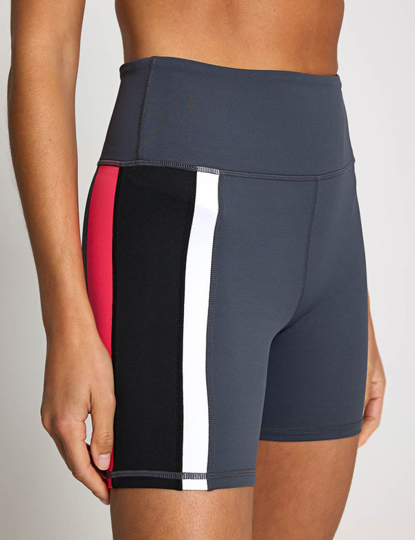 Athletic shorts with a color block design on a neutral background