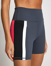 Athletic shorts with a color block design on a neutral background