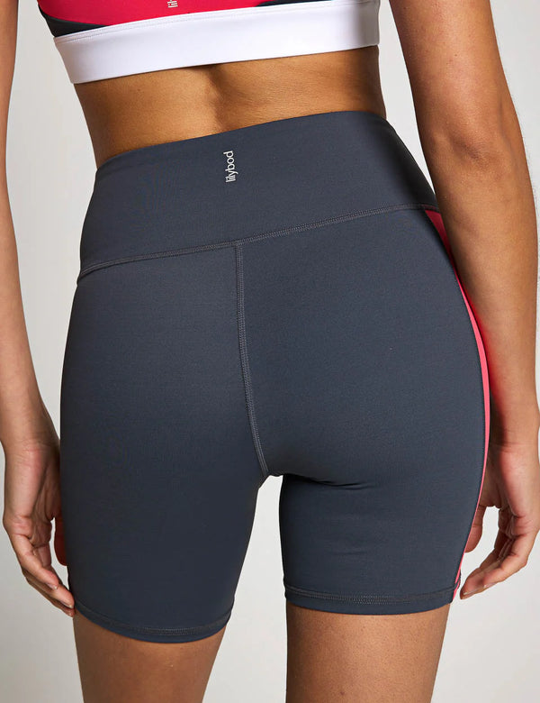 Dark gray athletic shorts with a red accent on a neutral background