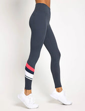Navy leggings with a red and white stripe on a white background