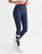 Navy leggings with green and white stripes worn by a woman on a white background