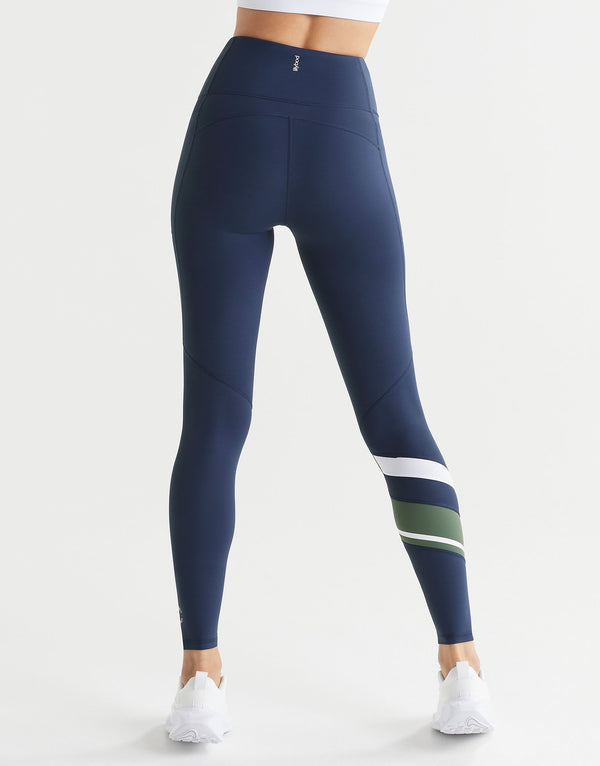 Navy leggings with white and green stripes on a white background