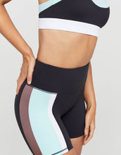 Athletic shorts with color-block design on a neutral background