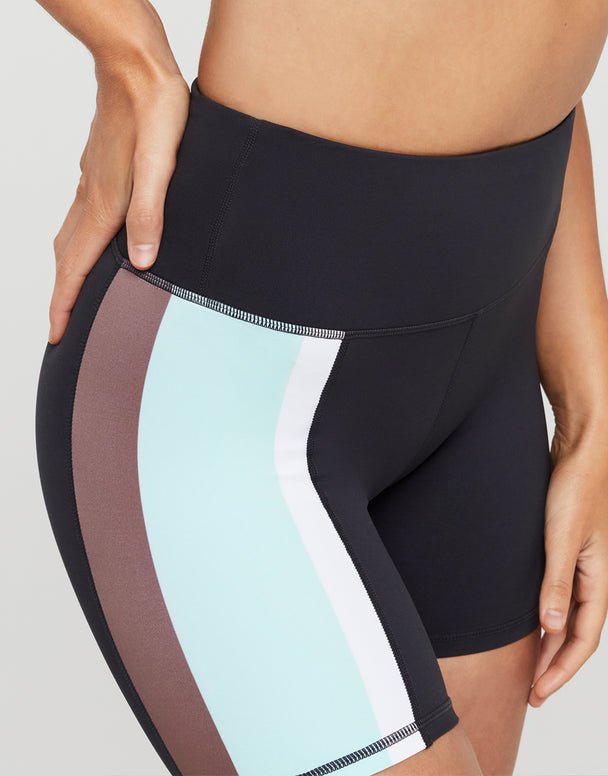 Black athletic shorts with color-blocked sides on a neutral background