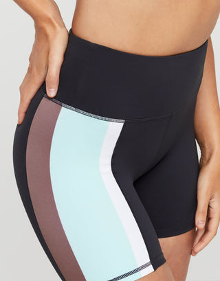 Black athletic shorts with color-blocked sides on a neutral background
