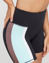Black athletic shorts with color-blocked sides on a neutral background