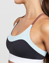 Multicolored sports bra on a neutral background