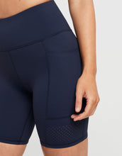 Navy blue athletic shorts with a pocket on a white background