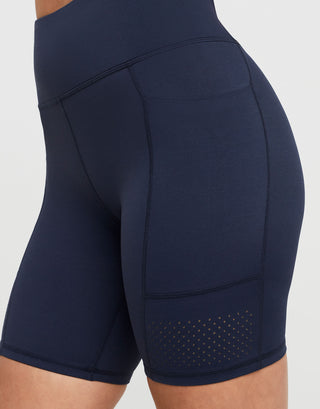 Navy blue activewear shorts with a white background