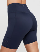 Navy blue athletic shorts with a brand logo on a light gray background