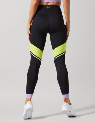 Black leggings with neon yellow and purple accents on a gray background