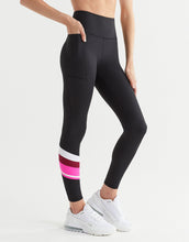 Black leggings with pink and white stripes worn by a person on a white background