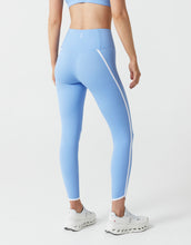Light blue leggings with a white stripe on a white background