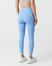Light blue leggings worn by a person on a white background