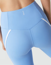 Light blue leggings with white accents on a neutral background